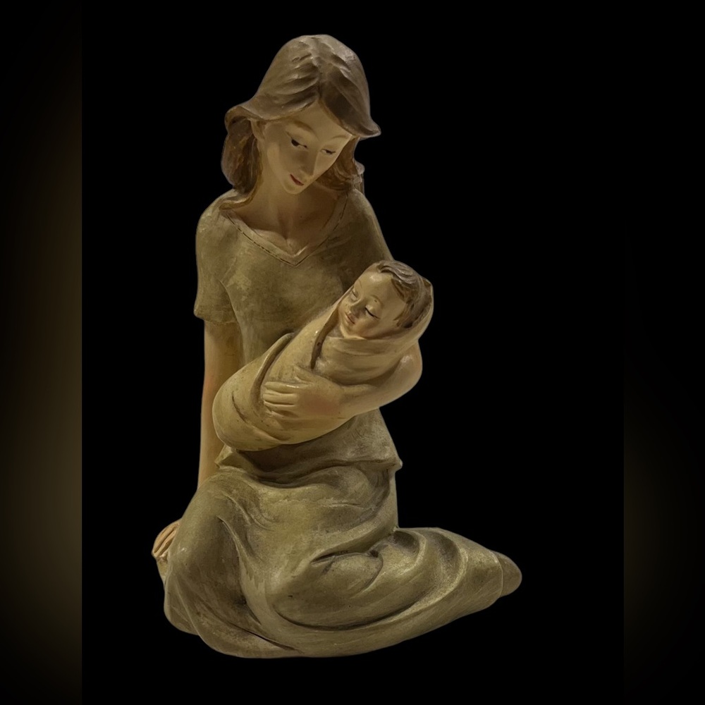 Mother Sitting holding infant figurine